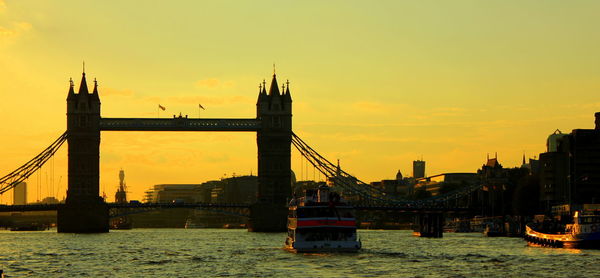 Bridge over river at sunset