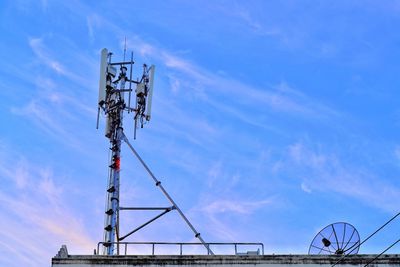 Low angle view of repeater tower against blue sky