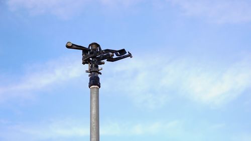 Low angle view of security camera against sky