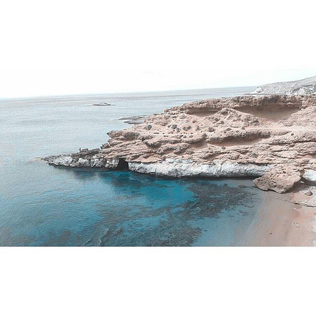 sea, water, horizon over water, tranquil scene, scenics, tranquility, clear sky, beauty in nature, beach, nature, copy space, shore, idyllic, blue, coastline, rock - object, seascape, rock formation, sky, day