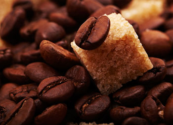 Detail shot of sugar cubes on coffee beans