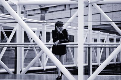 Woman looking away while sitting on staircase