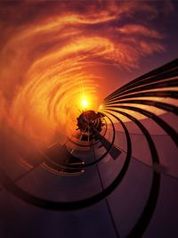 Low angle view of light trails on road against sky during sunset