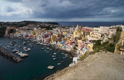 High angle view of townscape by sea against sky