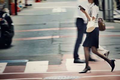 Blurred motion of people walking on street