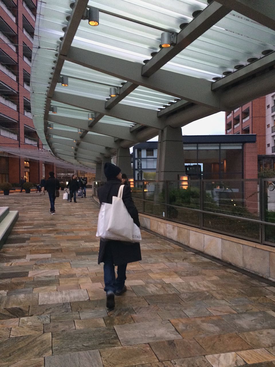 walking, lifestyles, built structure, men, architecture, person, full length, rear view, leisure activity, building exterior, city life, city, railroad station, the way forward, standing, railroad station platform, railroad track, incidental people