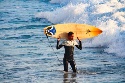 Full length of man standing in sea