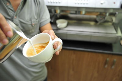 Midsection of man preparing food in kitchen