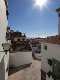 Houses against sky on sunny day