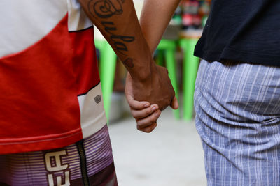 Rear view of couple standing in hands