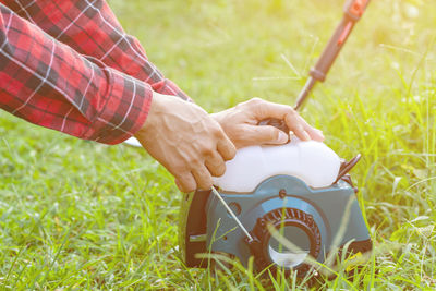 Cropped hand operating lawn mower