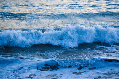 Beautiful shades of blue waves splashing on shore