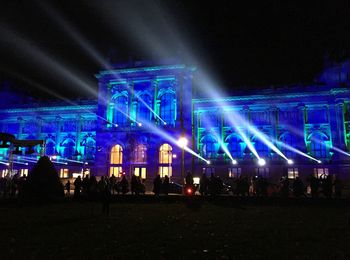 Group of people in illuminated building at night