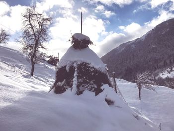 Scenic view of snow covered field against sky