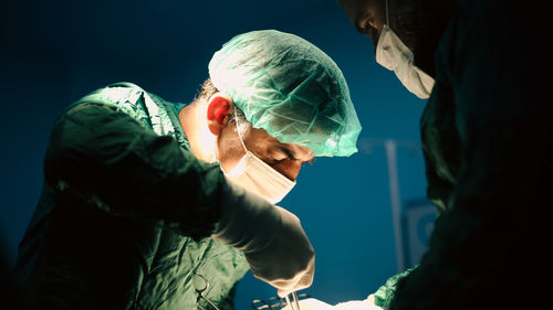 Doctors performing an appendectomy surgery, surgical concept.