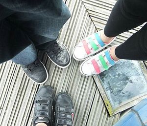 Low section of people standing on tiled floor