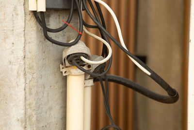 Close-up of metal pole against wall