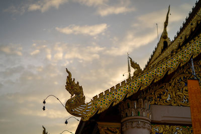 Low angle view of statues on building against sky