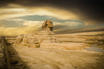 The great sphinx of giza against cloudy sunset sky