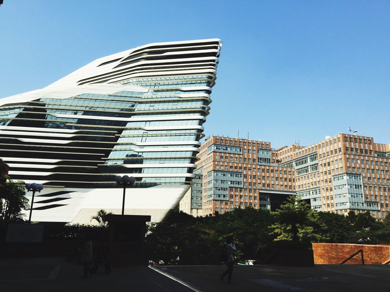 building exterior, architecture, built structure, clear sky, city, low angle view, modern, blue, residential structure, residential building, building, office building, sunlight, skyscraper, tree, tall - high, day, outdoors, copy space, city life