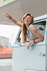 Portrait of smiling young woman in car