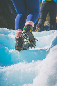 Low section of people hiking on snowcapped mountains