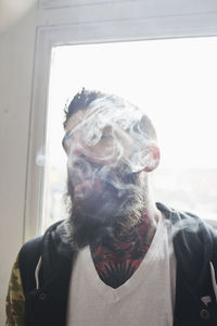 Young man with tattoos smoking