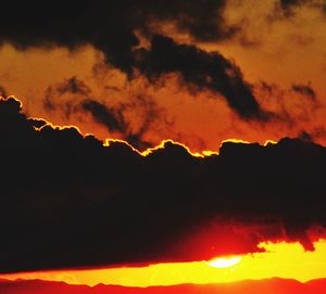 Scenic view of silhouette mountain against sky at sunset