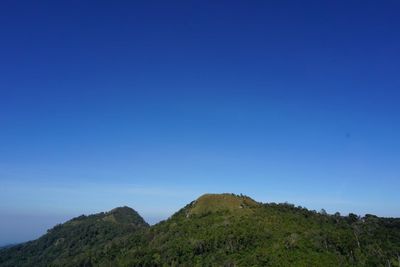 Scenic view of mountains against clear blue sky