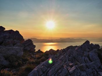 Scenic view of rocks against sky during sunset