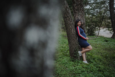 Portrait of young woman sitting on land