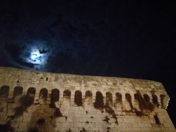 Low angle view of old ruin against sky at night