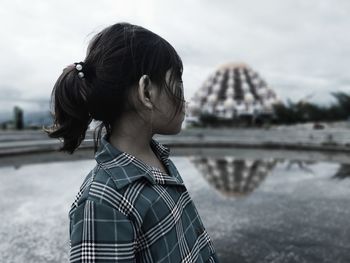 Portrait of young woman looking at mosque 99 dooms in makassar city