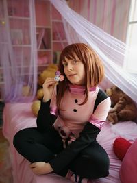 Portrait of a young woman sitting at home