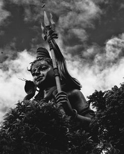 Low angle view of statue against sky