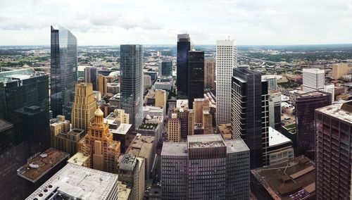 Aerial view of modern buildings in city against sky