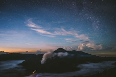 Scenic view of landscape against sky at night