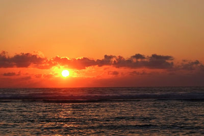 Scenic view of sea against romantic sky at sunset