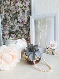 Close-up of rose bouquet with pearl accessories.