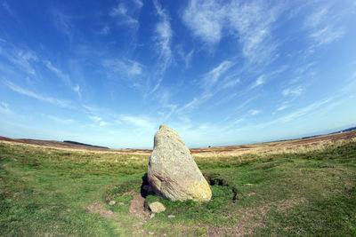 Hay bales on field against sky