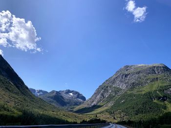 Scenic view of mountains against blue sky