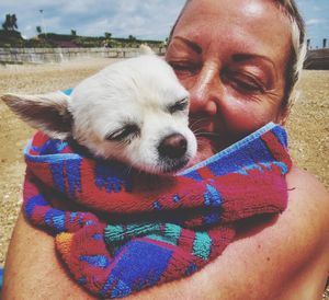 Close-up of woman with puppy outdoors