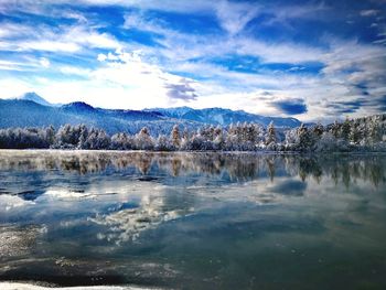 Scenic view of lake against sky during winter