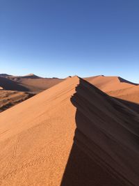 Scenic view of desert against clear sky