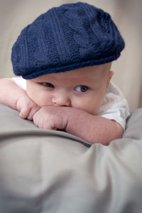 Cute baby boy with blanket looking away