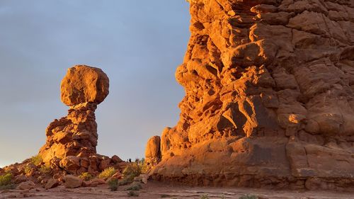 Glow of sunset on balanced rock in arches national park