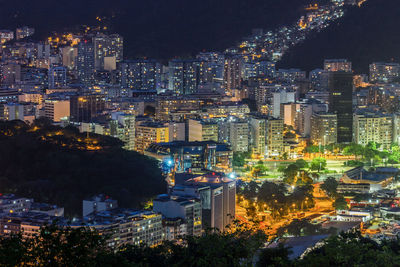 Illuminated cityscape against sky at night