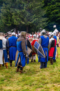 Close-up of people wearing suit of armor while standing outdoors