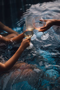 Ladies women friends with wine glasses cheers hot tub summer