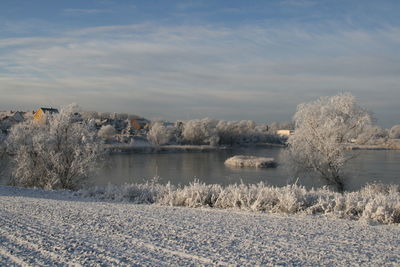 Scenic view of lake against sky during winter